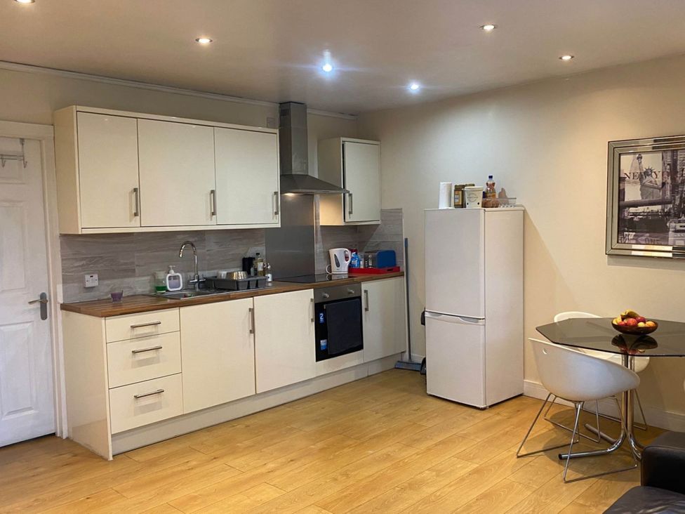 A kitchen with cabinets, sink, refrigerator, and a table at House - Sleeps 2 - Patio - Parking in High Wycombe