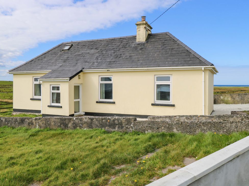 A house with a grey roof and multiple windows at Ocean View in Westport