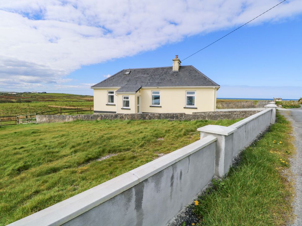A house with a fence and grass in front at Ocean View in Westport