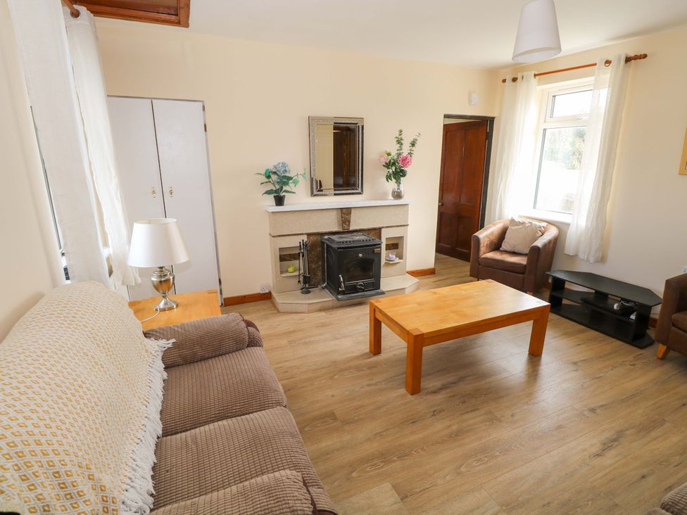 A living room with a fireplace and sofa at Ocean View in Westport