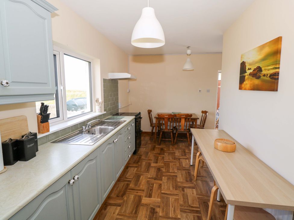 A kitchen with sink and table at Ocean View in Westport