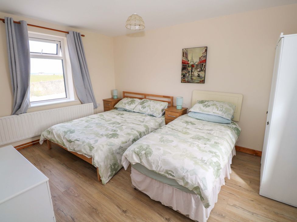 A bedroom with two single beds and a window at Ocean View in Westport