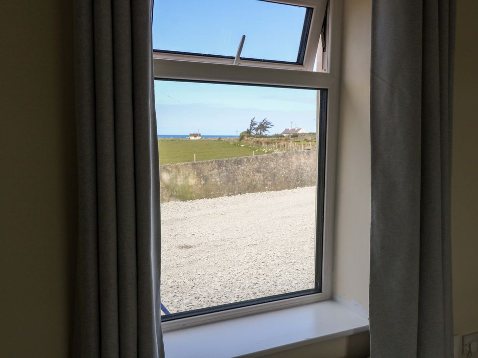 A window view of a landscape with sea and building at Ocean View, Westport