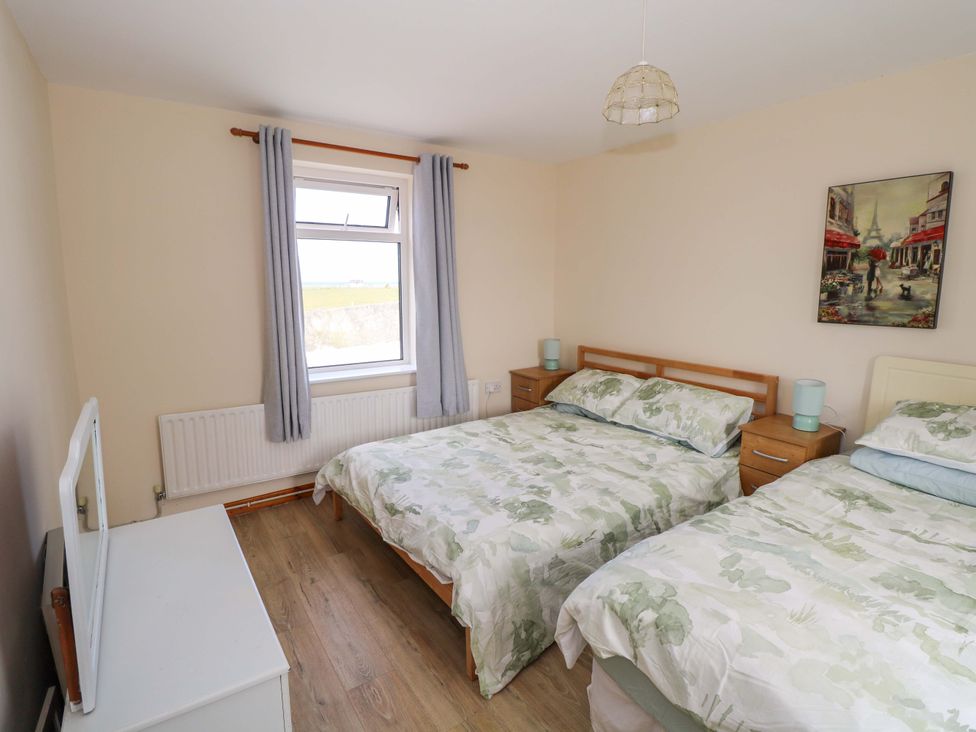 A bedroom with two beds and a television at Ocean View in Westport