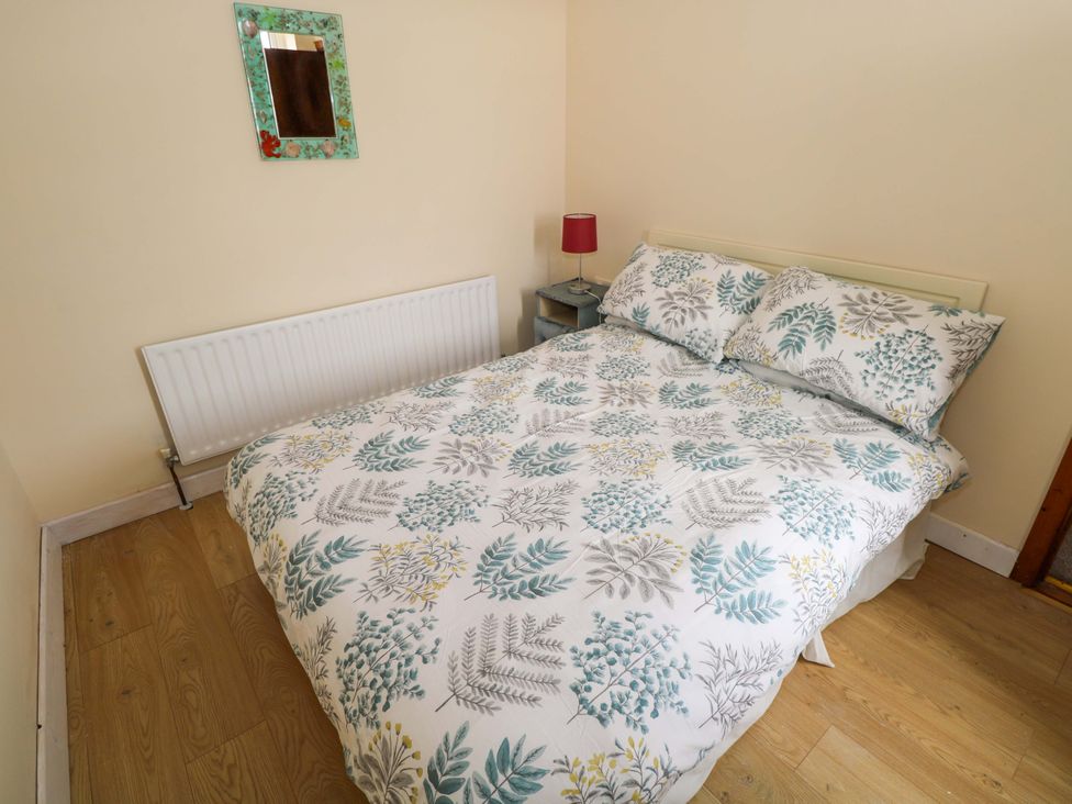 A bedroom with a bed and nightstand at Ocean View in Westport