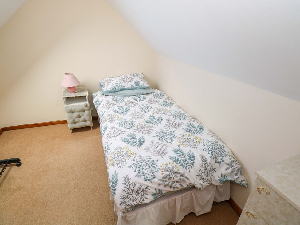 A bedroom with a bed and bedside table at Ocean View in Westport