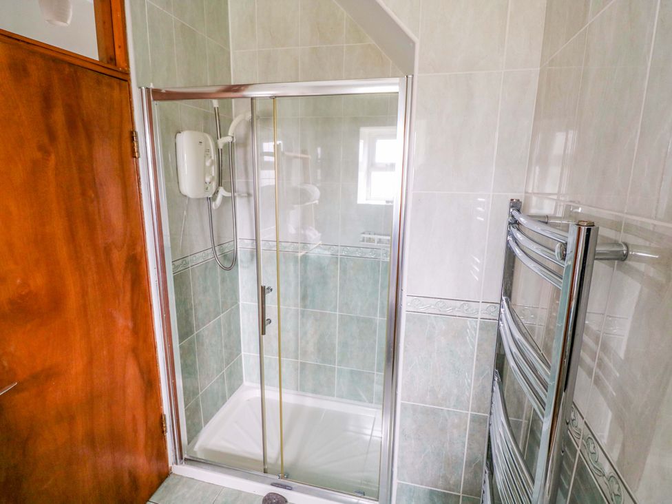 A bathroom with a shower and towel rail at Ocean View in Westport