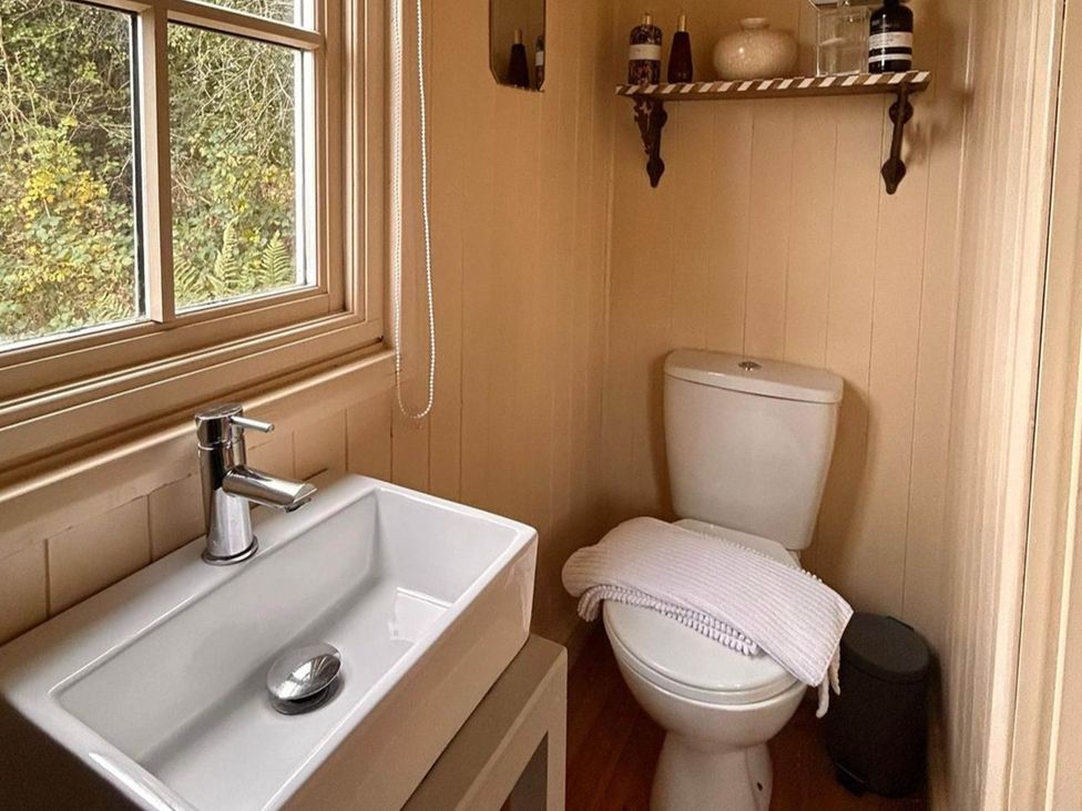 A bathroom with a sink and toilet at Cozy Cabin Retreat near Chepstow