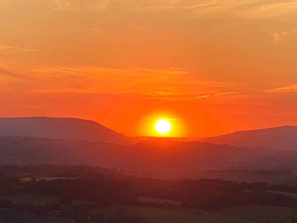 A sunset view over mountains at Cozy Cabin Retreat near Chepstow