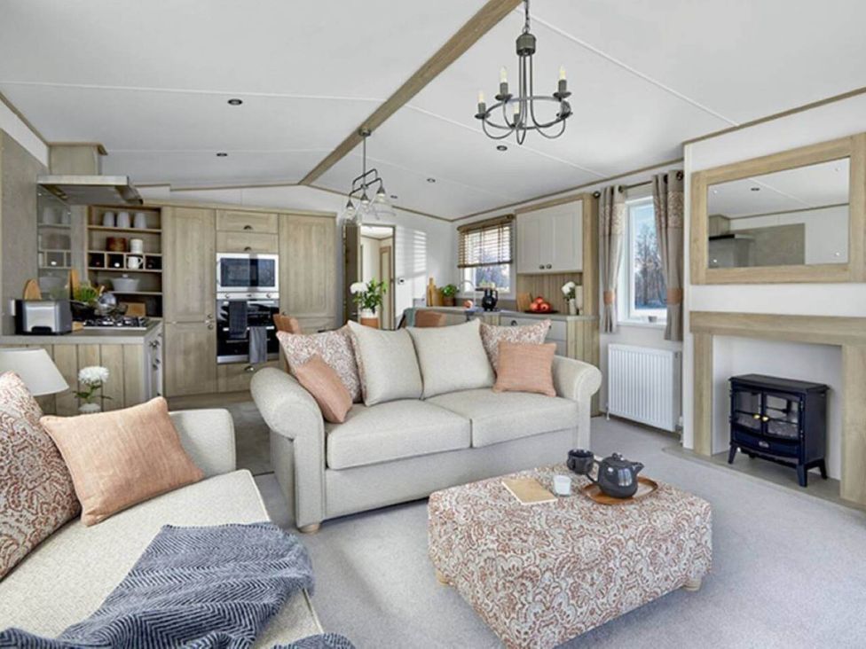 A living room with a sofa and coffee table at 2 Bed Lodge Sleeps 4 - Pet Welcome - Fireplace in Cirencester