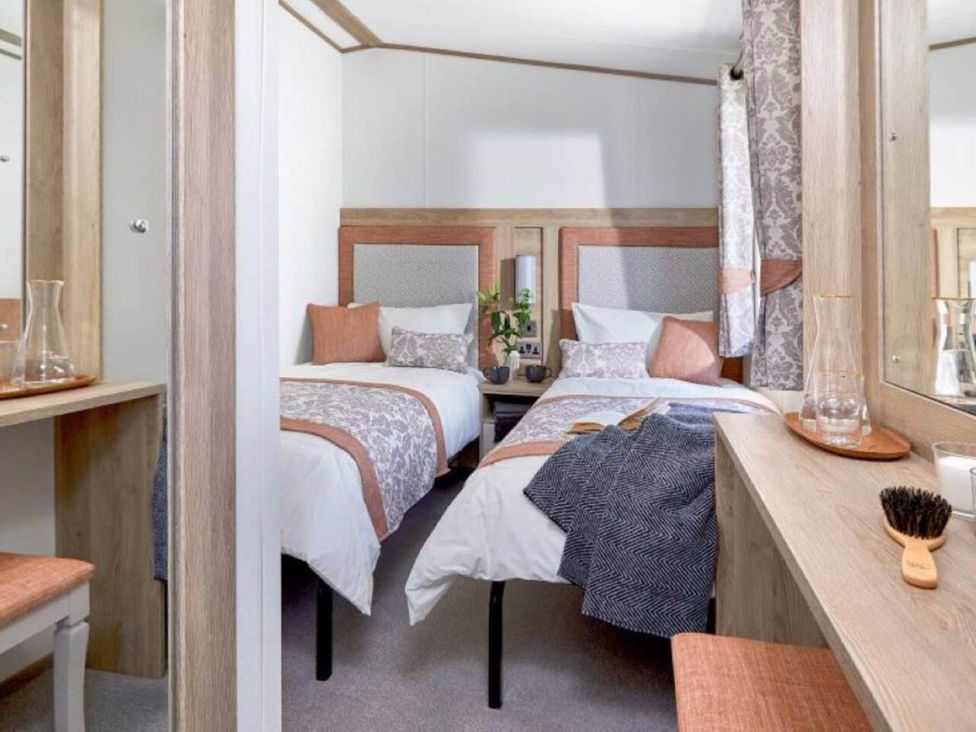 A bedroom with two beds and a mirror at 2 Bed Lodge Sleeps 4 - Pet Welcome - Fireplace Cirencester