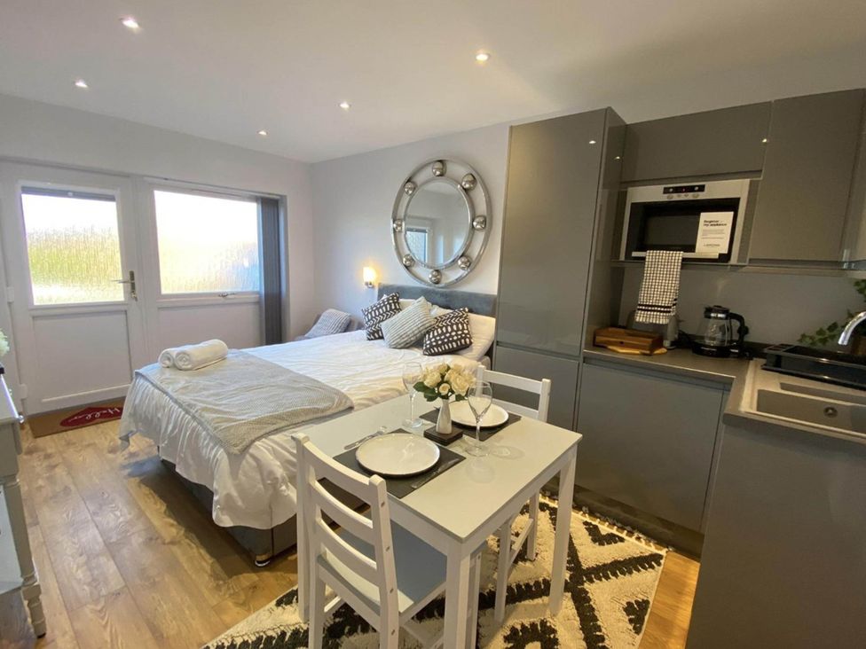 A studio with a bed and dining table at Beautiful 1-Bed studio in Penrith