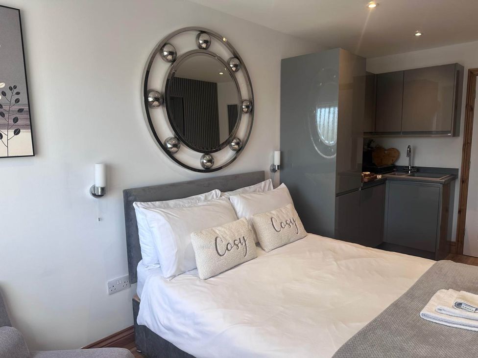 A bedroom with a bed and kitchenette at Beautiful 1-Bed studio in Penrith