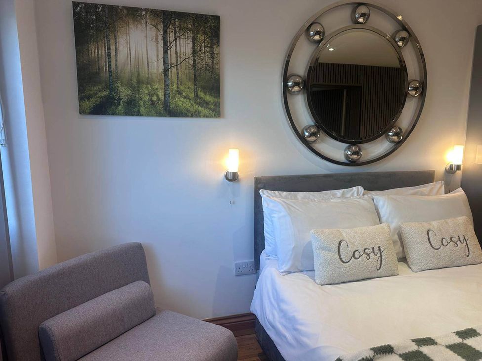A bedroom with a bed and wall decor at Beautiful 1-Bed studio in Penrith