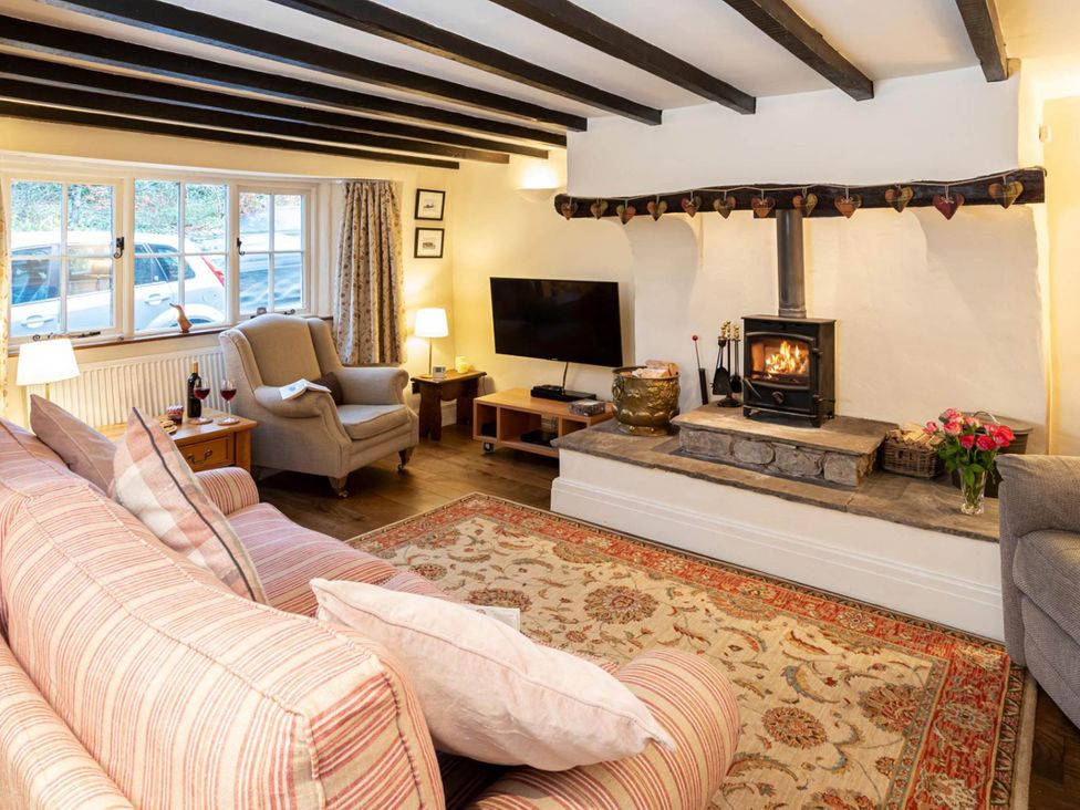 A living room with a fireplace and sofa at Ingleton 2-Bed Cottage, Sleeps 4, Pet Ok & Parking in Ingleton
