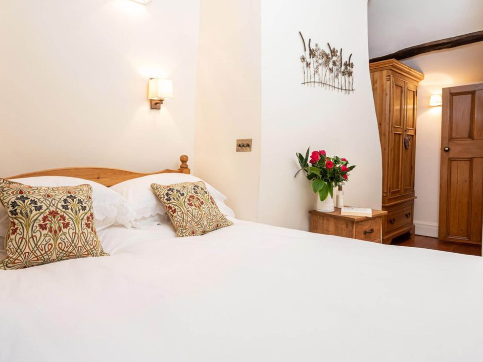 A bedroom with a bed, pillows, a lamp and a wardrobe at Ingleton 2-Bed Cottage, Sleeps 4, Pet Ok & Parking, Ingleton