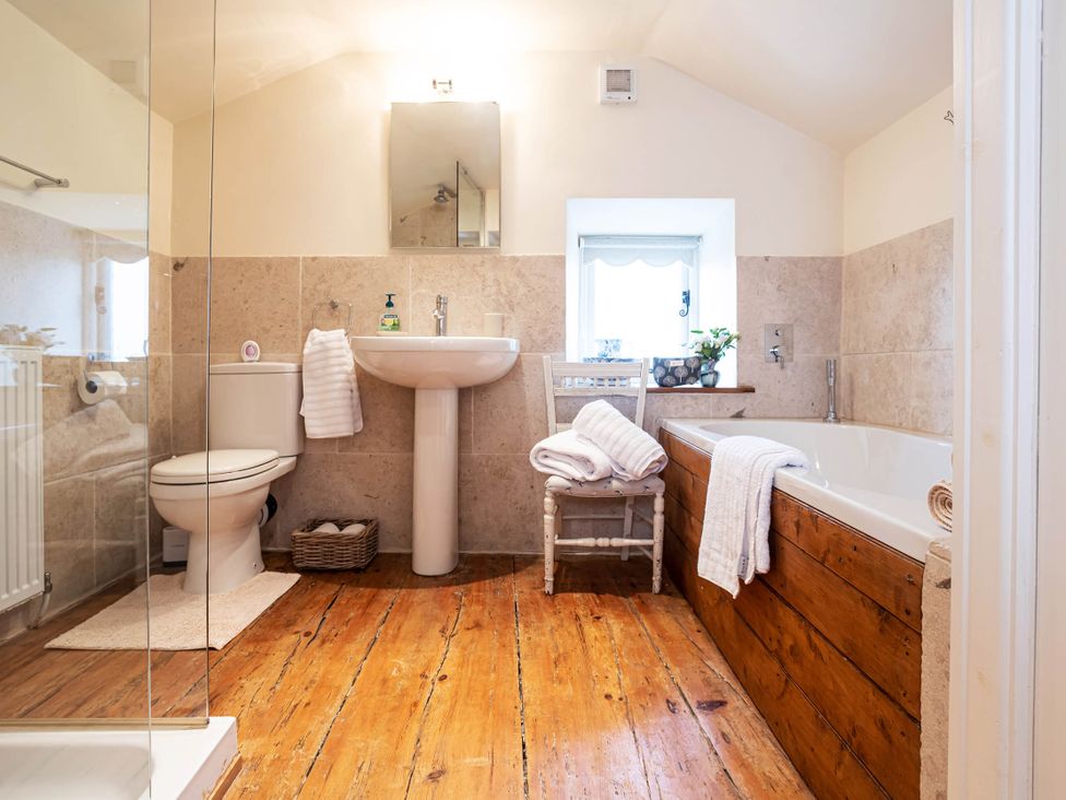 A bathroom with a sink, toilet, shower, and bathtub at Ingleton 2-Bed Cottage, Sleeps 4, Pet Ok & Parking, Ingleton