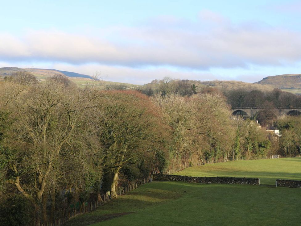 A view of trees and a field with a bridge in the background at Ingleton 2-Bed Cottage, Sleeps 4, Pet Ok & Parking, Ingleton