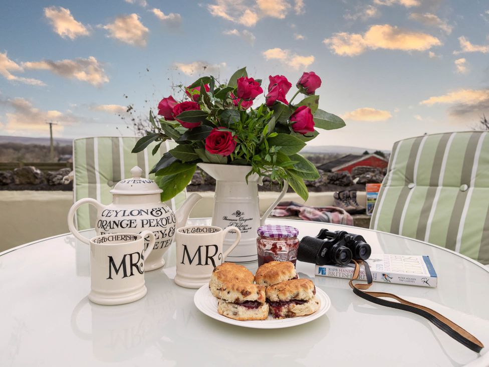 A table with scones, jam, flowers, and binoculars at Ingleton 2-Bed Cottage, Sleeps 4, Pet Ok & Parking, Ingleton