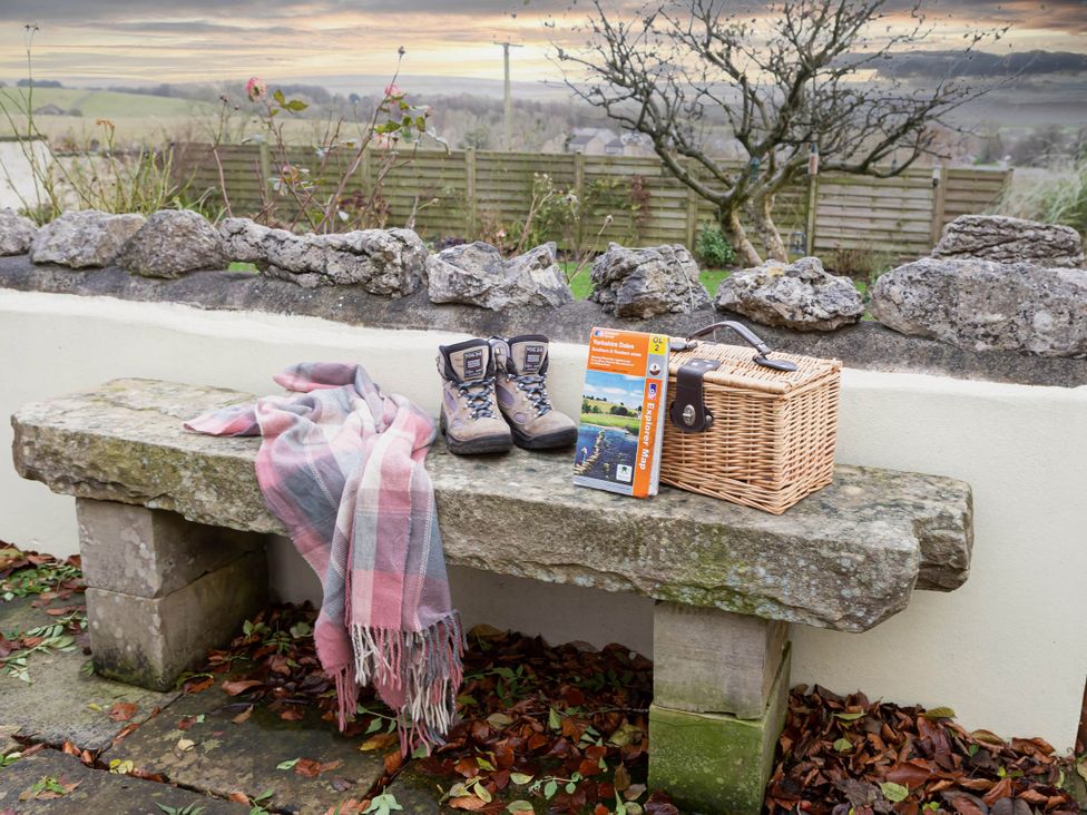 A stone bench with boots and a blanket at Ingleton 2-Bed Cottage, Sleeps 4, Pet Ok & Parking, Ingleton