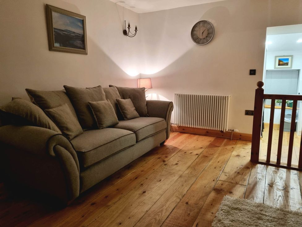 A living room with a sofa and lamp at The Coal Office in Aberlour