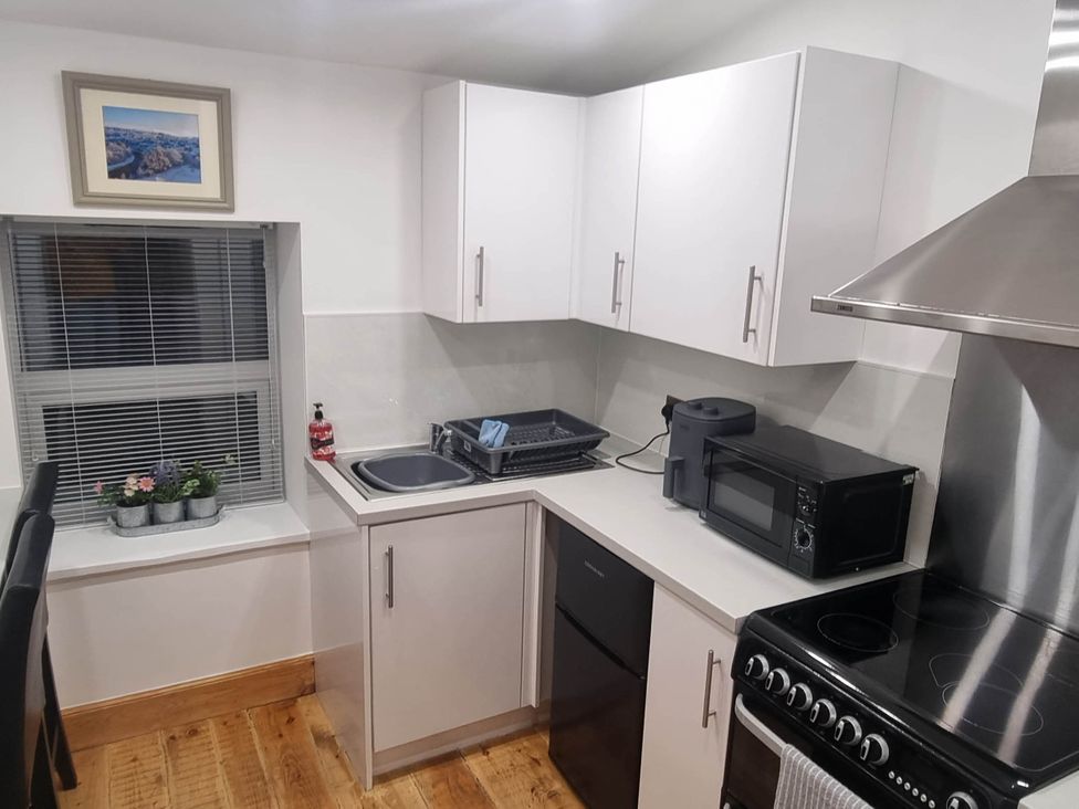 A kitchen with a sink and appliances at The Coal Office, Aberlour