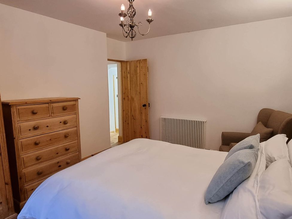 A bedroom with a bed and a chest of drawers at The Coal Office, Aberlour