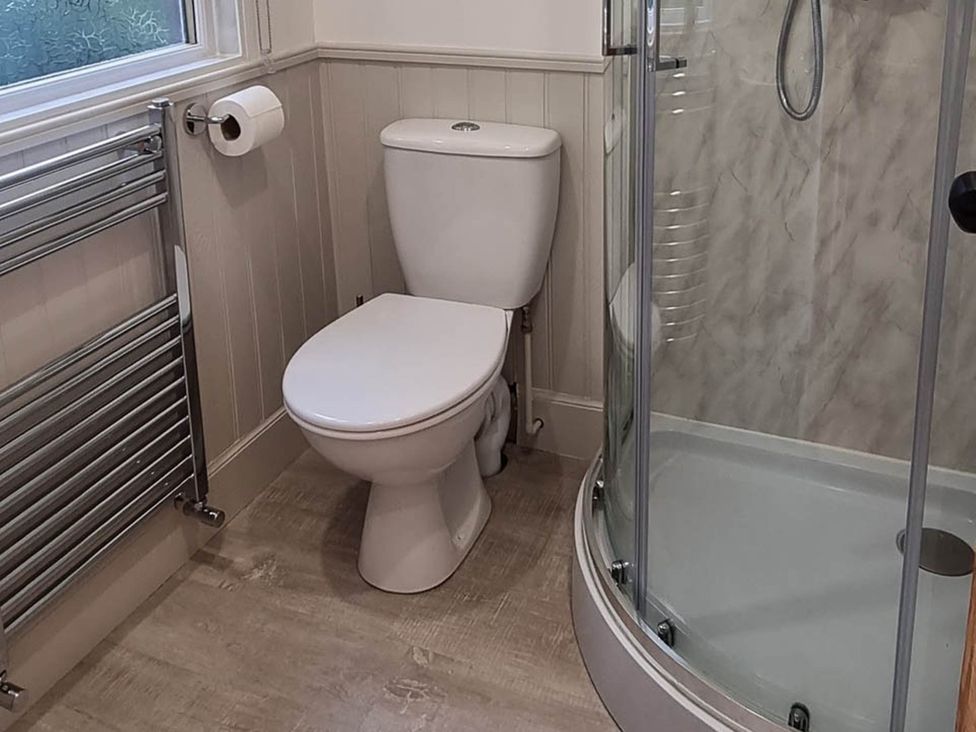 A bathroom with a toilet and shower at The Coal Office, Aberlour