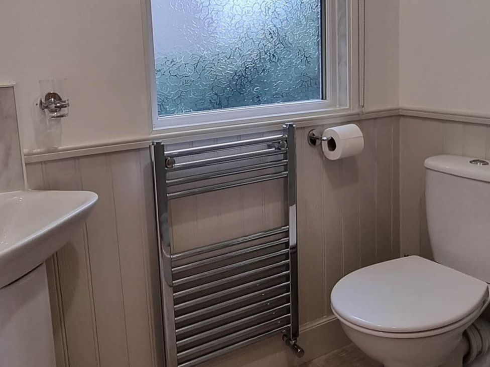 A bathroom with a sink, toilet, and towel radiator at The Coal Office, Aberlour