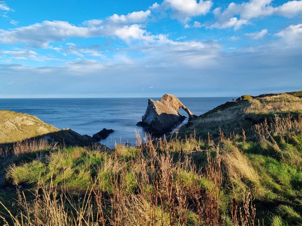 A coastal scene with a rock formation and ocean at The Coal Office, Aberlour