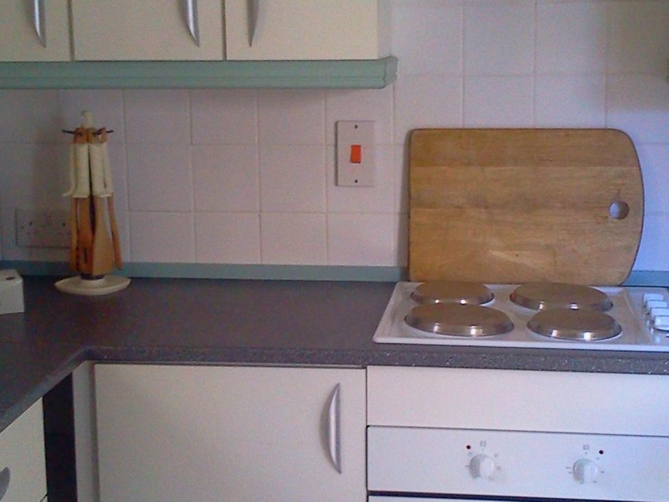 A kitchen with a counter, cooking hob, and chopping board at Cottage - Sleeps 4 - Pets Ok - Garden - Parking, Carnforth