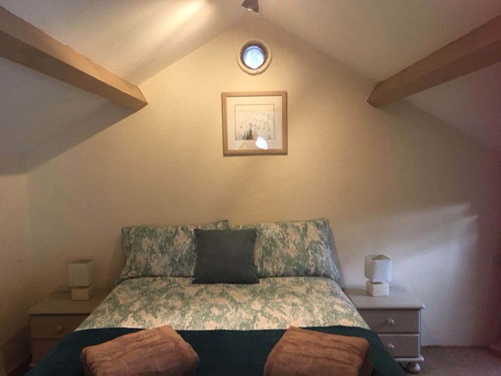A bedroom with a bed and bedside tables at Cottage - Sleeps 4 - Pets Ok - Garden - Parking in Carnforth