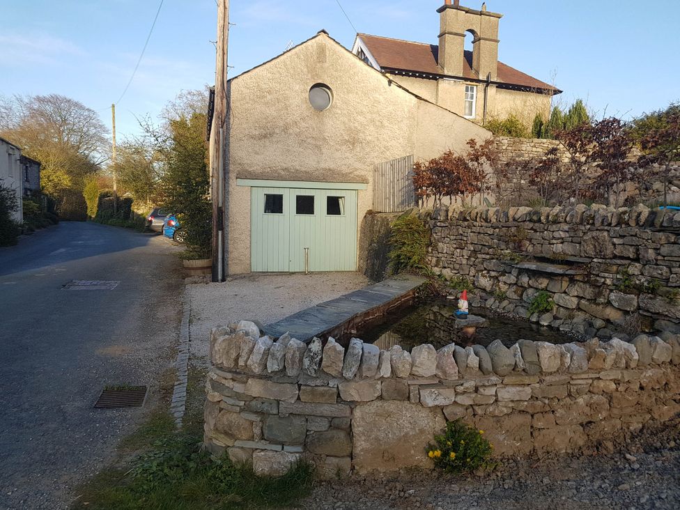 A garage and pond area at Cottage - Sleeps 4 - Pets Ok - Garden - Parking in Carnforth