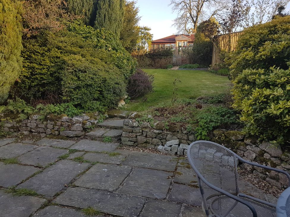 A garden with a stone path and bushes at Cottage - Sleeps 4 - Pets Ok - Garden - Parking in Carnforth
