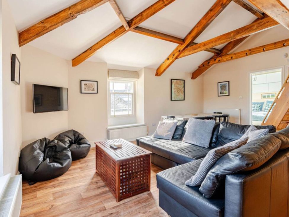 A living room with a sofa and coffee table at Sedbergh Penthouse - KingBed - Tv - Wifi Sedbergh