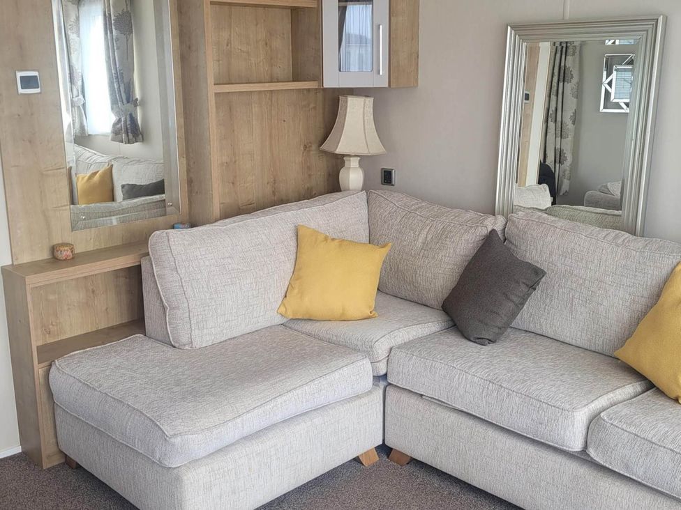 A living room with a grey sofa and lamp at Beachside Lodge - Sleeps 6 - Pets ok - Parking in Heysham