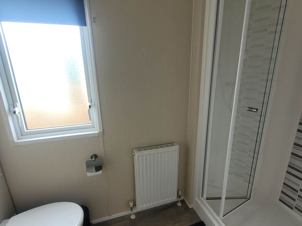 A bathroom with a shower and toilet at Beachside Lodge - Sleeps 6 - Pets ok - Parking Heysham