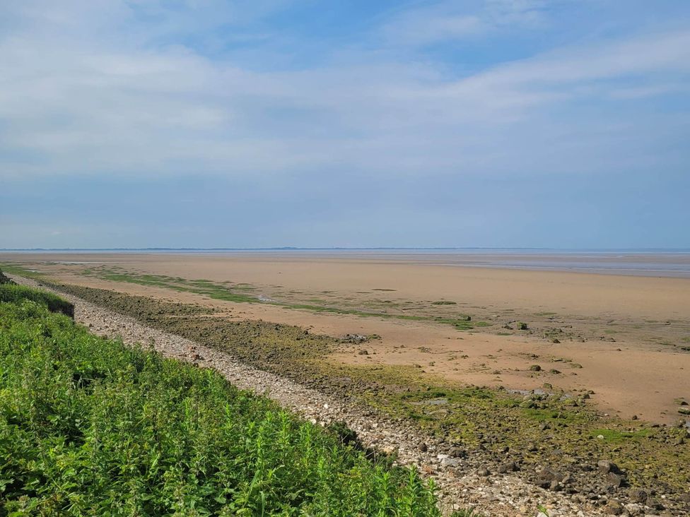 A beach with sand and water at Beachside Lodge - Sleeps 6 - Pets ok - Parking in Heysham