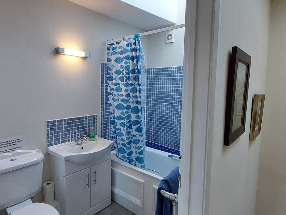 A bathroom with a toilet and sink at Cosy Cottage for two in the centre of Sedbergh
