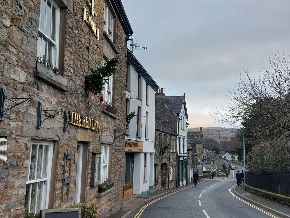 A street view with buildings and a road at Cosy Cottage for two in the centre of Sedbergh