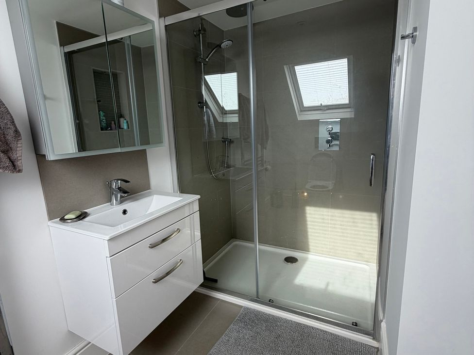 A bathroom with a shower and sink at Lorrell in Salcombe