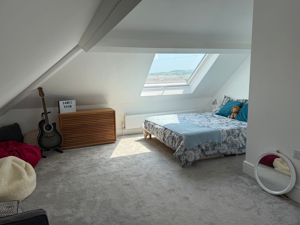 A bedroom with a bed and guitar at Lorrell in Salcombe