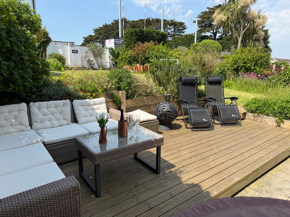 A garden with outdoor seating and plants at Lorrell in Salcombe