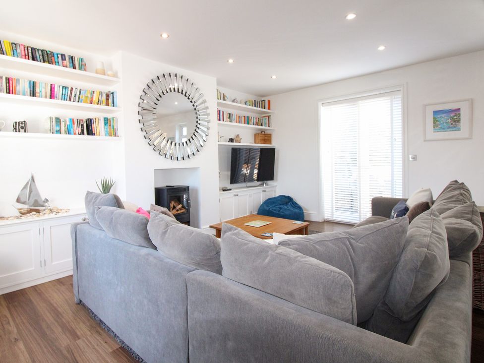 A living room with a sofa and television at Lorrell in Salcombe