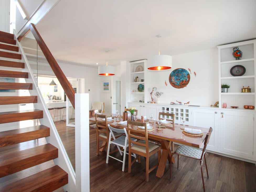 A dining room with a table and chairs at Lorrell in Salcombe