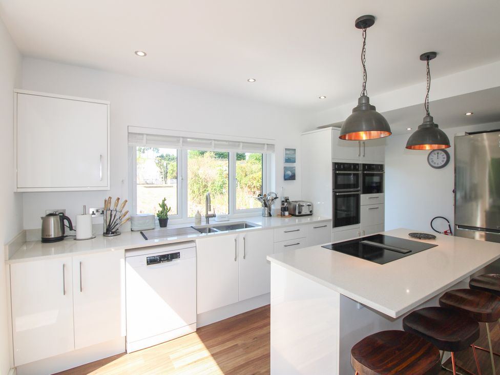 A kitchen with a sink and appliances at Lorrell in Salcombe