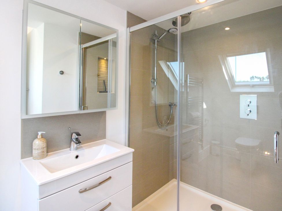A bathroom with a sink and shower at Lorrell in Salcombe