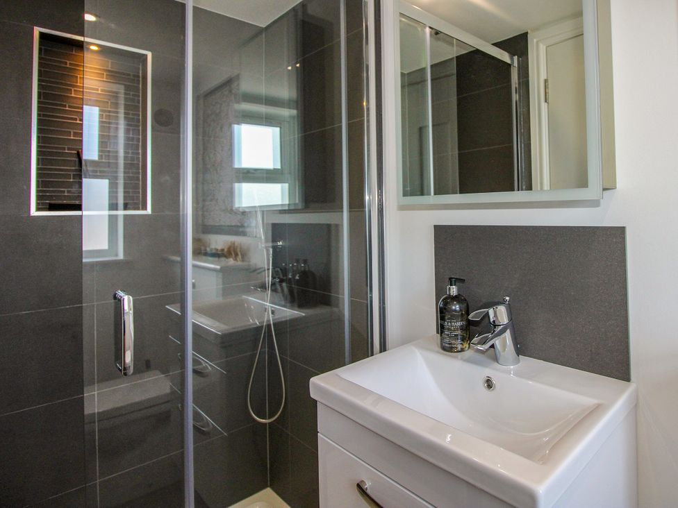A bathroom with a shower and sink at Lorrell in Salcombe