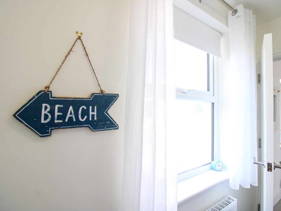 A beach sign and a window in an interior space at Lorrell Salcombe