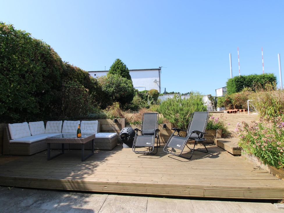 A garden with outdoor furniture and sun loungers at Lorrell Salcombe